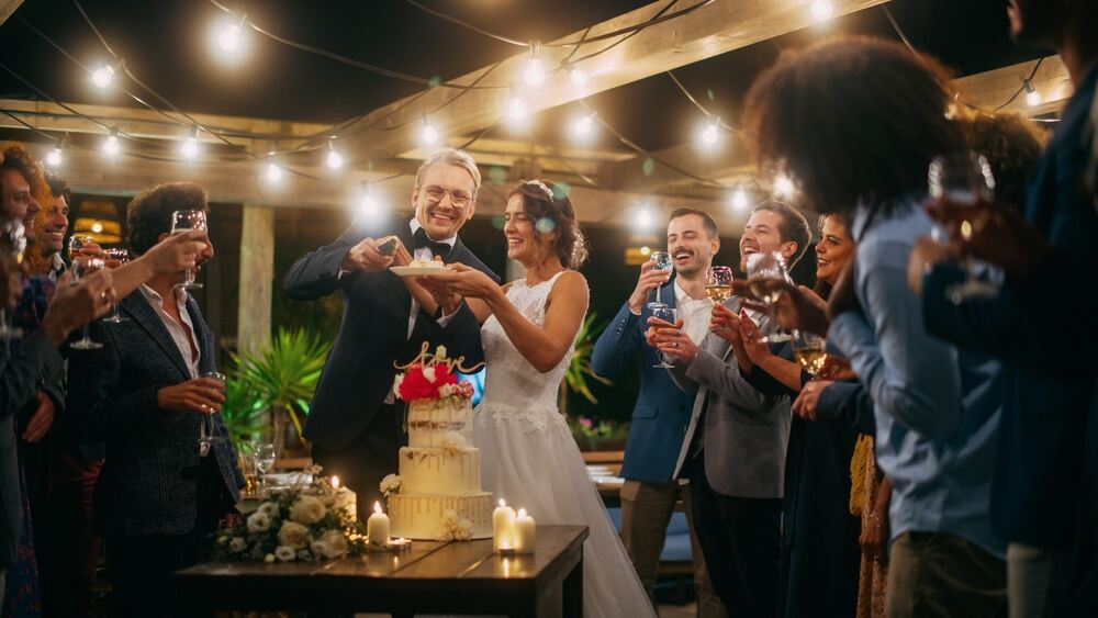 A bride and groom cut the cake at an all inclusive wedding venue