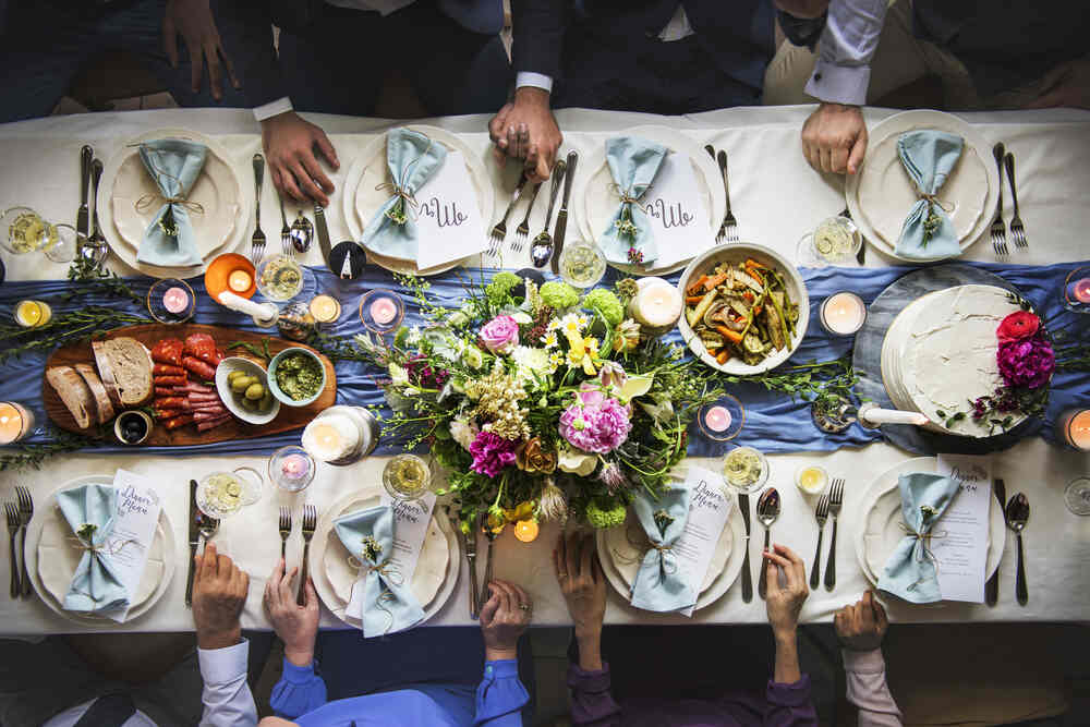 Aerial view of a wedding table at an all inclusive venue, including cutlery, flowers, and linens