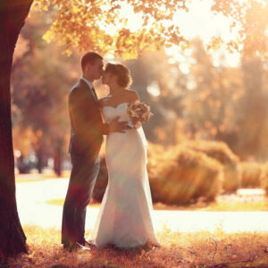 A bride and groom strike a romantic pose in front of the Asheville, NC, foliage