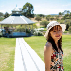 An excited bride-to-be tours a wedding venue with a gazebo 