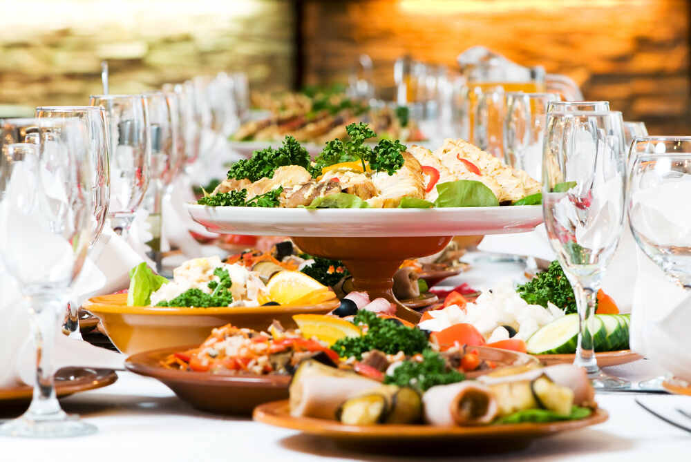 A catering table set for service featuring a locally-inspired menu