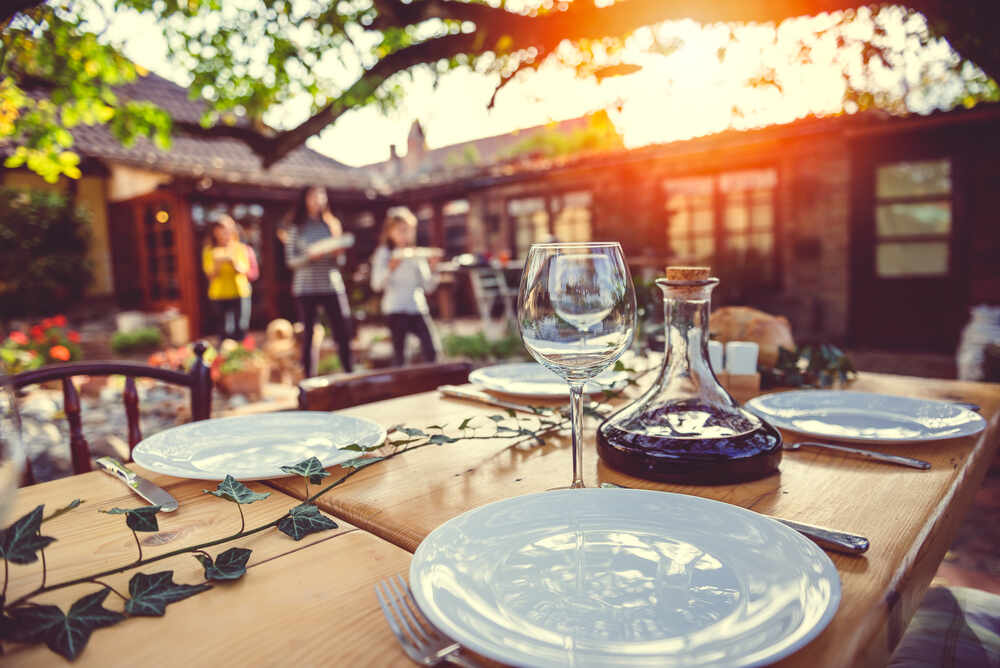 A table setting at an outdoor catering venue at sunset