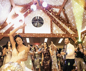 Bride dancing with a disco ball at a wedding reception