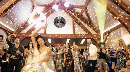 Bride dancing with a disco ball at a wedding reception