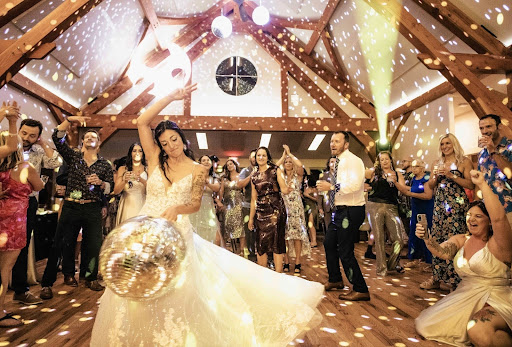 Bride dancing with a disco ball at a wedding reception