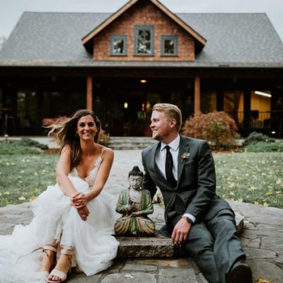 wedding couple in front of Asheville wedding venue - Weaver House